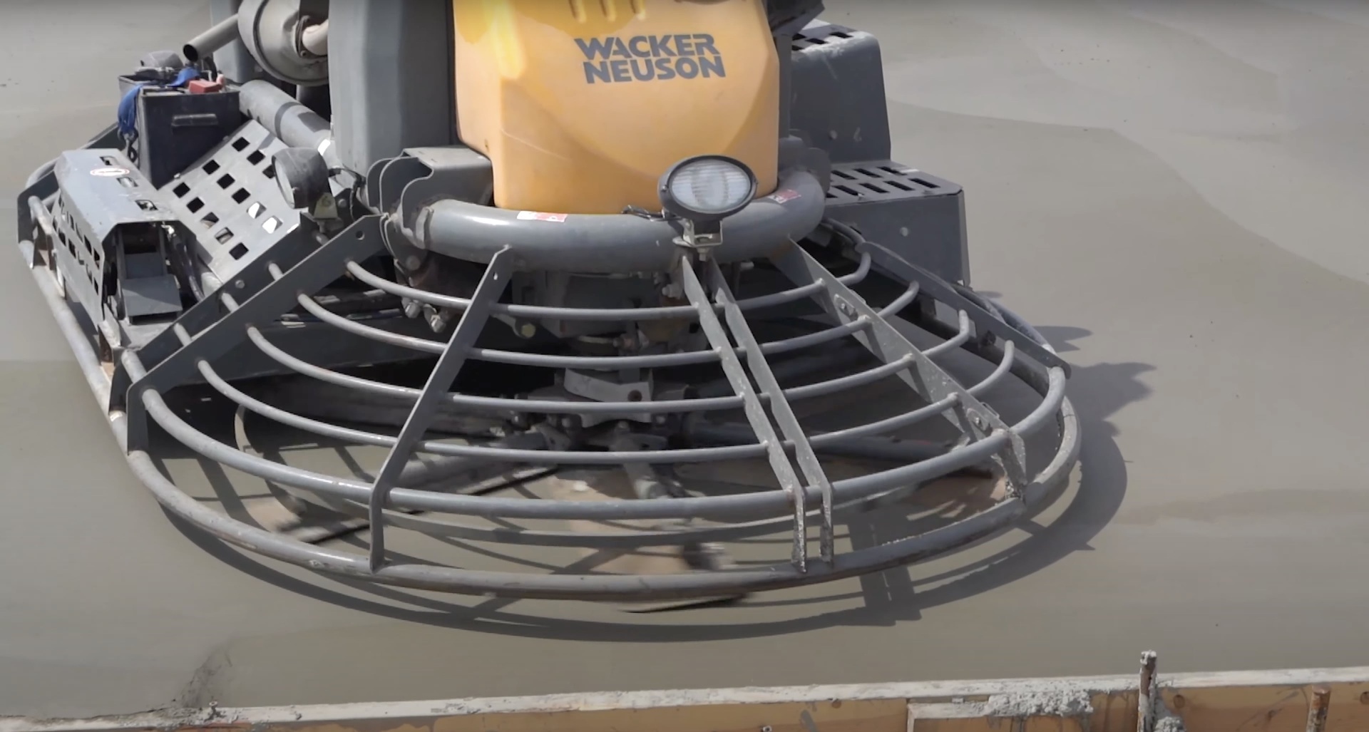 Professional concrete finishing equipment used by Dover Concrete Construction Professional concrete finishing equipment showing power trowel used for smooth concrete surfaces