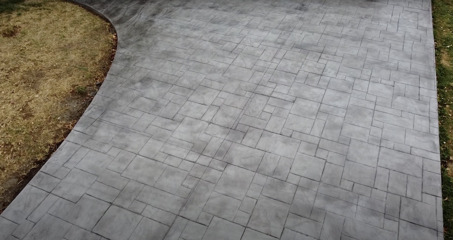 Stamped concrete patio with herringbone pattern by Dover Concrete Construction Beautiful stamped concrete patio with herringbone pattern showing professional installation