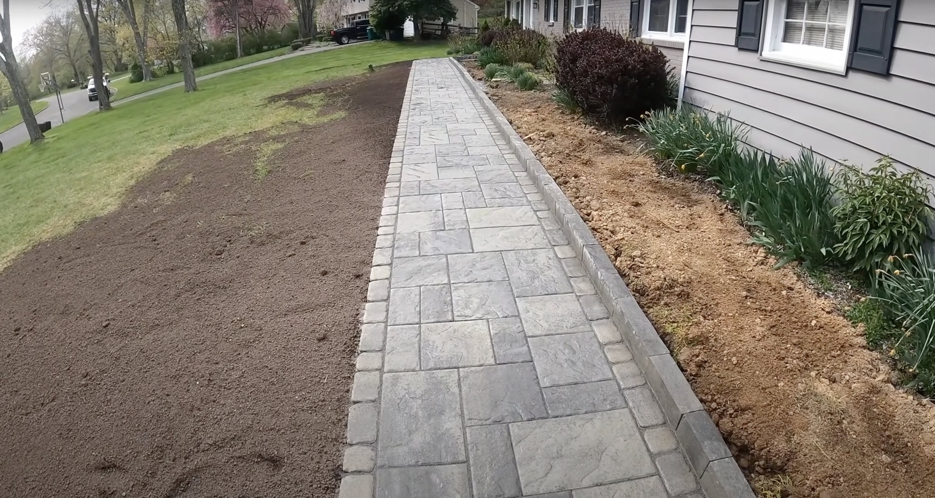Stamped concrete walkway installation by Dover Concrete Construction Stamped concrete walkway with natural stone pattern leading to residential entrance